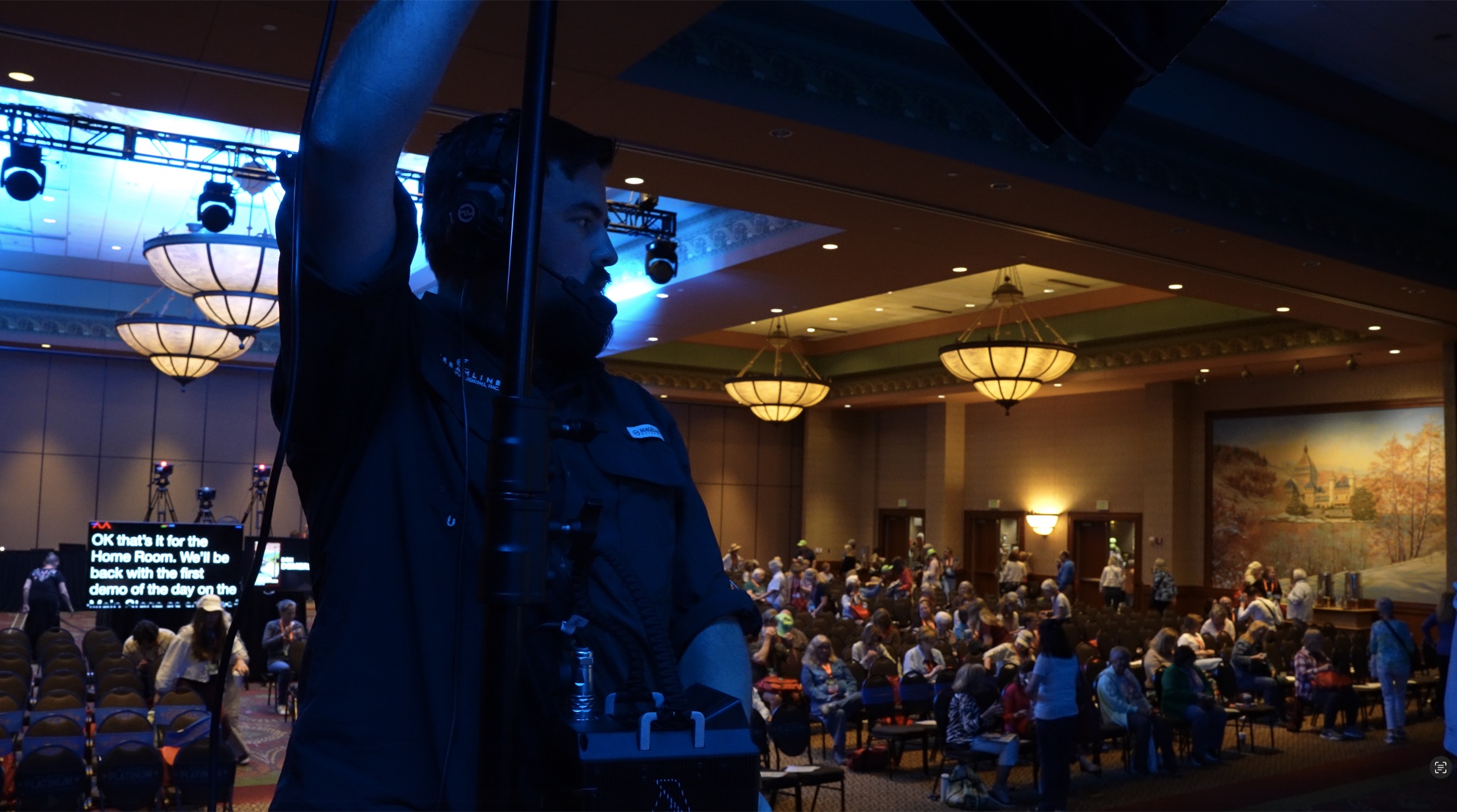 Arron working above a full PACE room during a live production